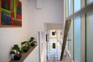 a hallway with potted plants and a stair case at Grosvenor House - Olympic Pool - Pattaya in Pattaya South