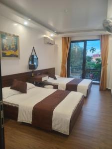 Postel nebo postele na pokoji v ubytování Quang Minh Hotel + 19 fotografií