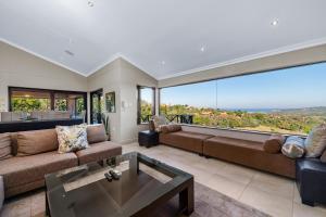 a living room with a couch and a table at San Lameer Villa 14205 - 4 Bedroom Luxury - 8 pax -San Lameer Rental Agency in Southbroom