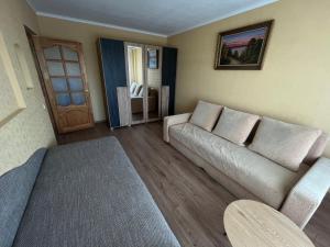 a living room with a couch and a table at saules street apartment in Ventspils