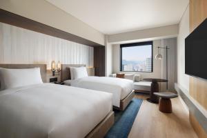 Postel nebo postele na pokoji v ubytování Courtyard by Marriott Sapporo