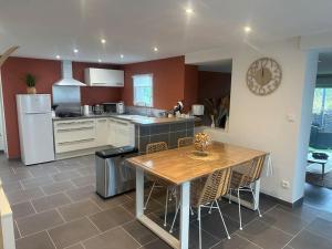 a kitchen with a table with chairs and a counter top at Logement cosy proche plage wissant in Marquise