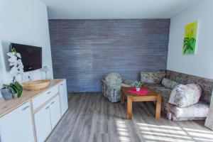 a living room with a couch and a table at Huberhof 5 by Alpenidyll Apartments in Rohrmoos