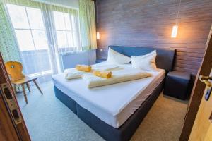 a bedroom with a bed with two pillows on it at Huberhof 5 by Alpenidyll Apartments in Rohrmoos