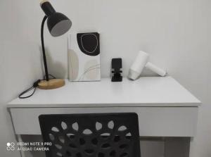 a white desk with a lamp and a speaker at Semenyih Setia Ecohill 2 Free Wifi in Beranang