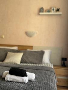 a bedroom with two beds with towels on them at Студия Sea Breeze in Sveti Vlas