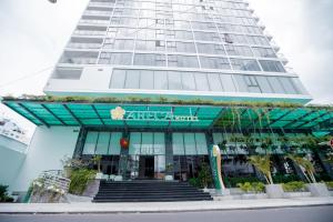 a tall building with a building at Areca Hotel Nha Trang in Nha Trang