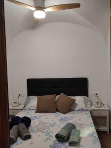 a bedroom with a bed with a black headboard and pillows at La Casita de Pela in Navalvillar de Pela