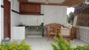 a kitchen with a table and chairs on a patio at Kubah Bali Glamping in Kintamani