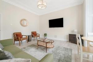 a living room with a couch and a table at Modern Two Bedroom Central Flat in Weston-super-Mare