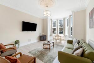 a living room with a couch and a tv at Modern Two Bedroom Central Flat in Weston-super-Mare