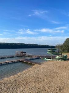 a dock on a lake with boats in the water at Apartament w Welskiej Kamienicy in Lidzbark +9 photos