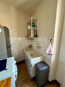 a small kitchen with a sink and a refrigerator at La Petite Ourse maison de village à Oust in Oust +39 photos