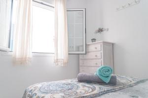 a bedroom with a bed with a mirror and a dresser at Daydream Medano Coliving in El Médano