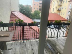 a balcony with potted plants on a fence at Apartma Mladinska in Maribor