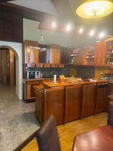 a kitchen with wooden cabinets and a counter top at Apartma Mladinska in Maribor
