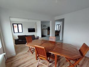 - une salle à manger et un salon avec une table et des chaises en bois dans l'établissement La colloc rue des bulles, à Pont-à-Mousson