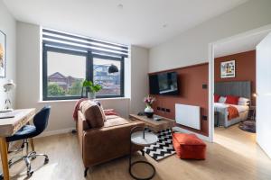 a living room with a desk and a bedroom at Kula Birmingham - New Street Station in Birmingham +119 photos
