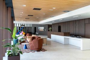 an office lobby with a reception desk and chairs at Parador de Molina de Aragón in Molina de Aragón