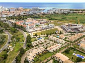 an aerial view of a city with the ocean in the background at Casa das Mélias in Vilamoura