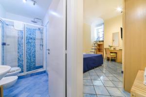 a bathroom with a shower and a toilet and a sink at Sharon House in Amalfi +44 photos