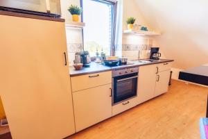a kitchen with white appliances and a window at Romantik Studio - Cozy - Stylisch - Naturnah in Kempen