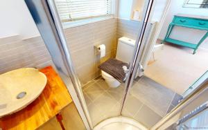 a small bathroom with a toilet and a sink at CROYDE MARRAM 5 Bedrooms in Croyde +38 photos