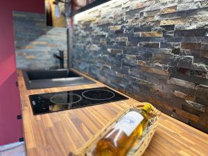 a bottle of beer sitting on top of a kitchen counter at Le bout du chemin in Treize-Vents