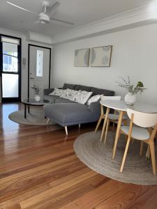 a living room with a couch and a table at Stylish & Elegant 2BR Townhouse in Wilston, Brisbane in Brisbane +23 photos
