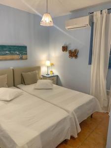 a bedroom with two beds and a light at Villa Lida Spetses - Private Pool in Spetses