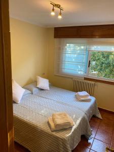a bedroom with two beds with towels on them at Chalet adosado independiente en Vigo - Canido in Oya