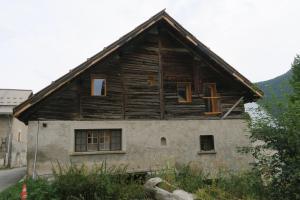 a wooden house with windows on the side of it at Le Grenier 1746 in Névache