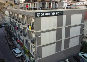 a building with a sign for grand park hotel at Grand Faik Hotel in Çeşme