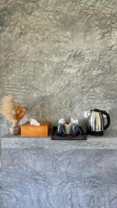a tray with a tea pot and a tea kettle at Picha house Kohyaonoi in Ban Laem Sai +33 photos