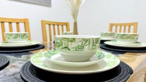 a table with plates and cups on a table at 4 Hills Properties - Everest in Cross Gates