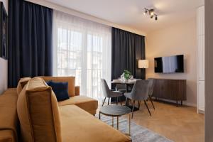 a living room with a couch and a table at Metropolis Old Town Apartments in Kraków