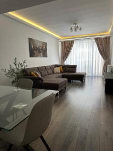 a living room with a couch and a table at La Gigi in Braşov