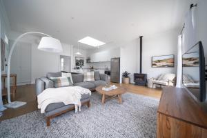 a living room with a couch and a table at Field Street Cottages 'Studio' - Centrally Located Luxury in McLaren Vale