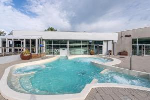 a large swimming pool in front of a building at Village Pierre & Vacances Belle Dune in Fort-Mahon-Plage +99 photos
