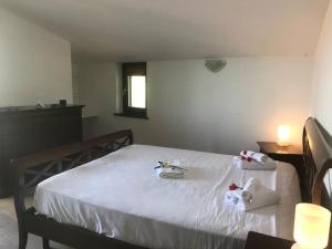 a bedroom with a white bed with towels on it at La casa langhetta in Albaretto Della Torre 