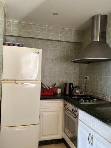 a kitchen with white cabinets and a white refrigerator at Namaa Bay hotel Chalet in Sharm El Sheikh