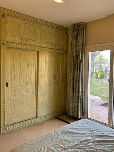 a bedroom with a bed and a sliding glass door at Namaa Bay hotel Chalet in Sharm El Sheikh +18 photos