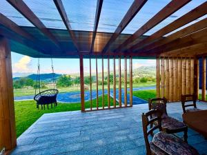 a screened in porch with a view of a pool at Nemes Chalet A Frame in Văleni