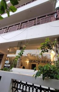 a store window with the words beach rescue on it at tippys beach resort in Kovalam