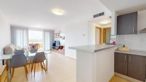 a kitchen and living room with a table and chairs at Mar Menor Golf Resort in Murcia