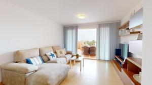 a living room with a couch and a tv at Mar Menor Golf Resort in Murcia