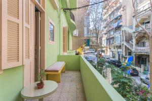 a balcony with a table and a view of a street at SAYA La Villa in Mar Mikhael in Beirut