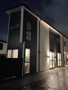 a large building with its doors open at night at 5 bedroom house at the heart of Auckland Airport in Auckland