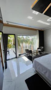 a bedroom with a bed and a view of a patio at Oasis TIFNIT Villa with Pool View No vis A vis in Draïd +130 photos