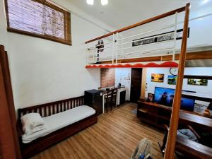 a bedroom with a bunk bed and a desk at The River House - Govantes Guesthouse in Vigan